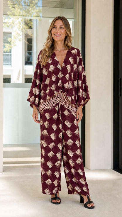 Woman wearing burgundy geometric print two-piece set