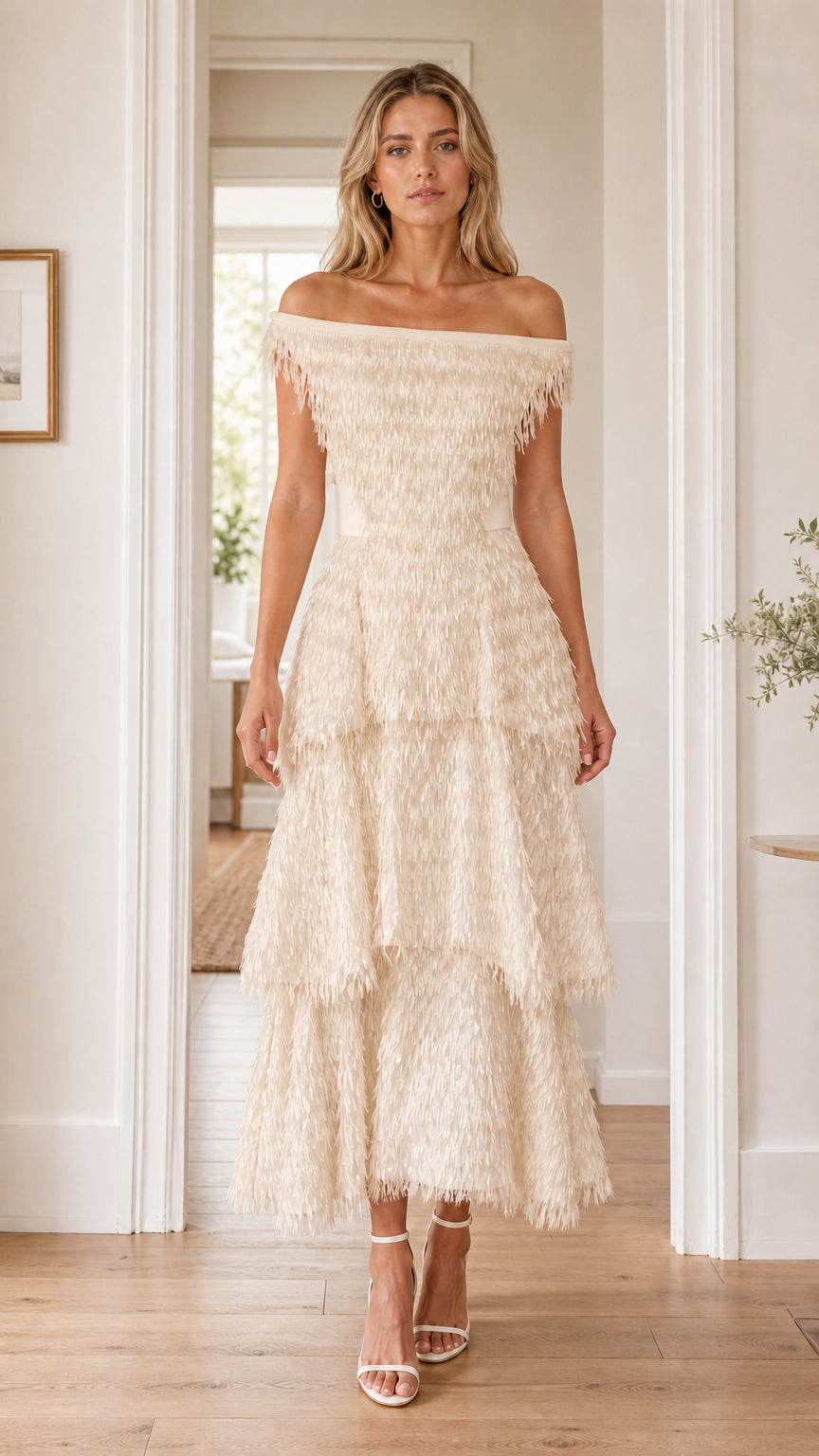 Front view of woman in champagne off-the-shoulder fringe dress