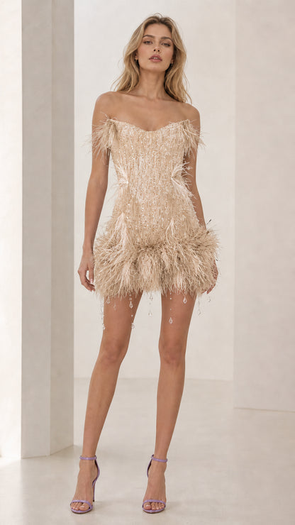 Model wearing champagne feather trim sequin mini dress