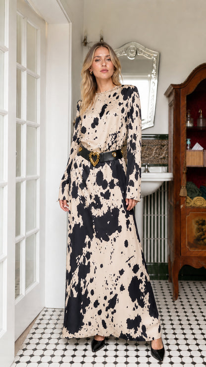 Woman wearing beige cow print long sleeve maxi dress with belt