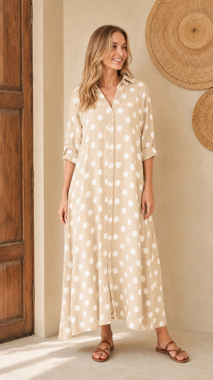 Front view of woman wearing beige polka dot maxi shirt dress
