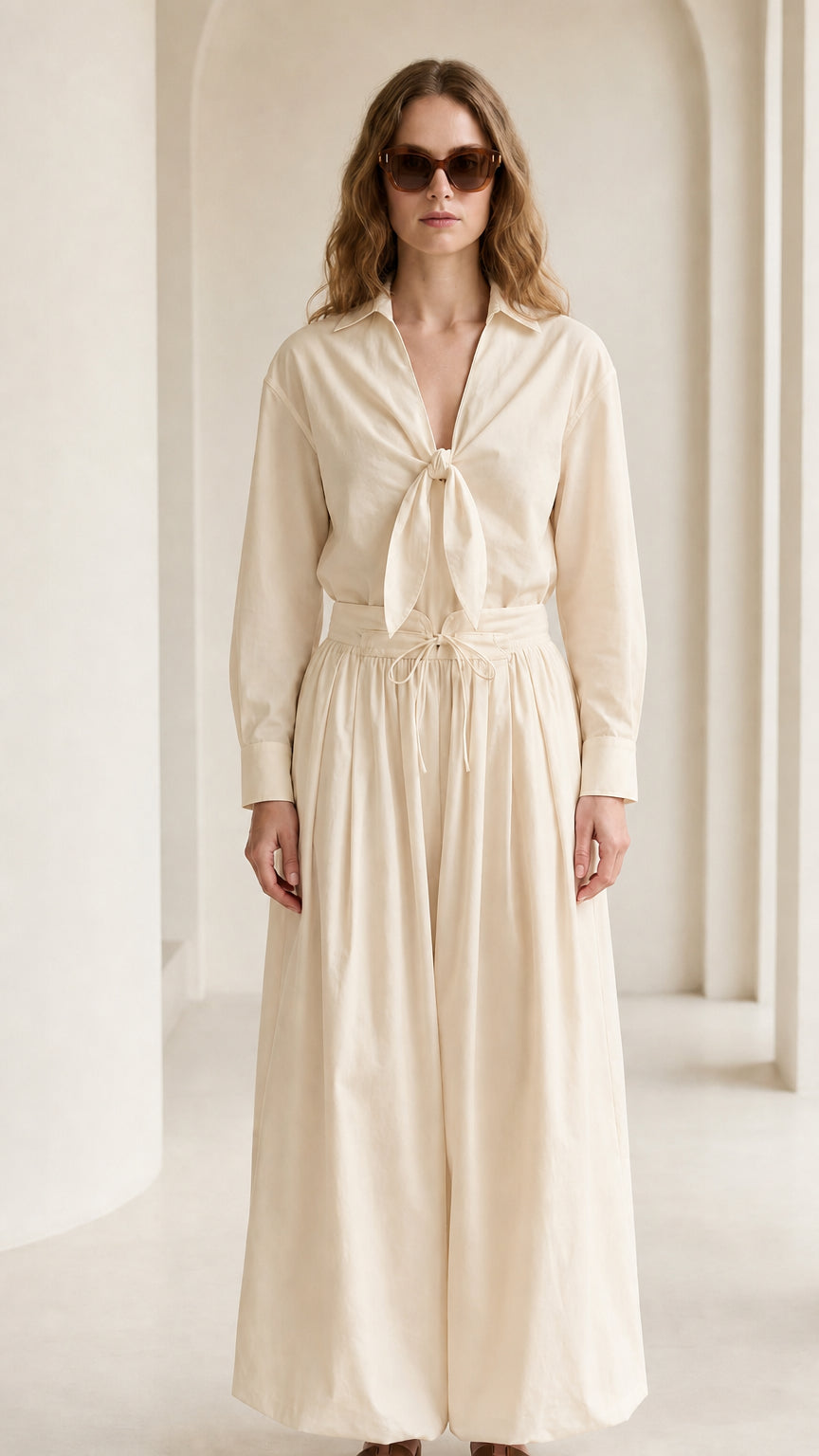 Woman wearing cream tie-front shirt and wide-leg pants set