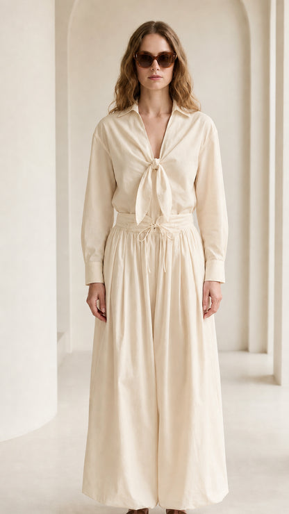 Woman wearing cream tie-front shirt and wide-leg pants set