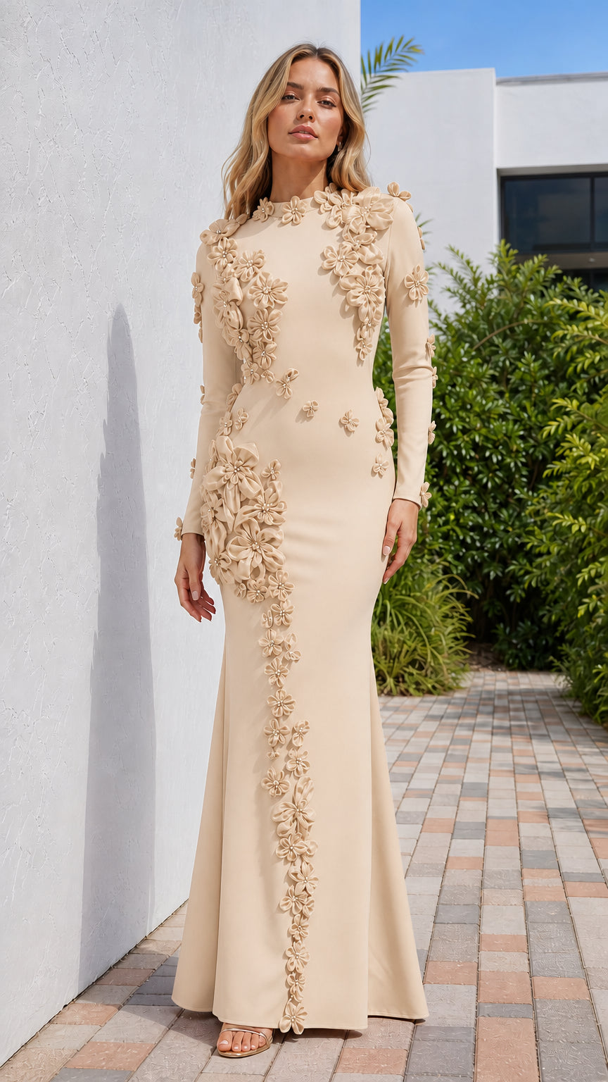 Front view of model wearing champagne long sleeve evening gown