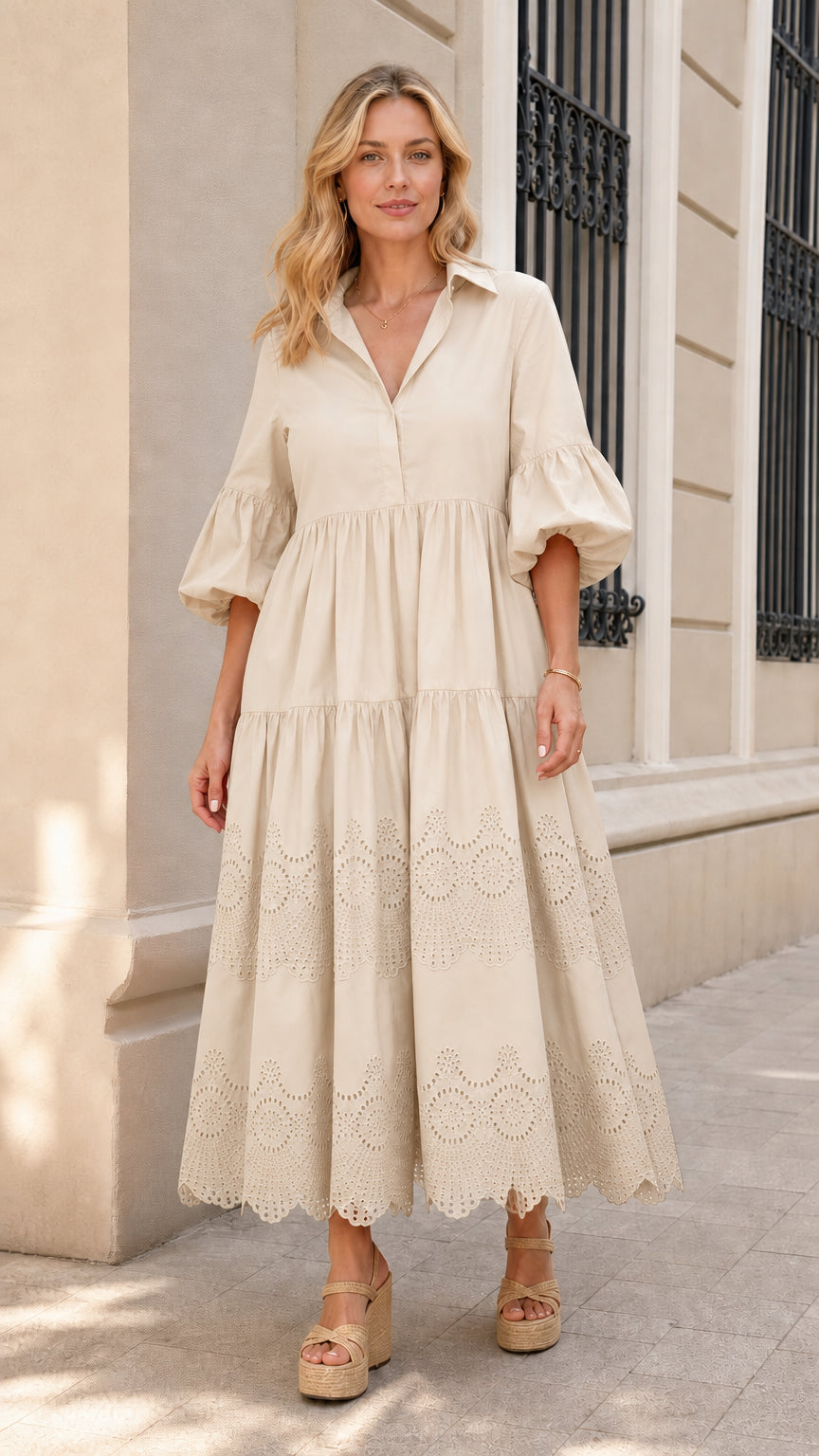 Front view of woman wearing beige collared tiered midi dress