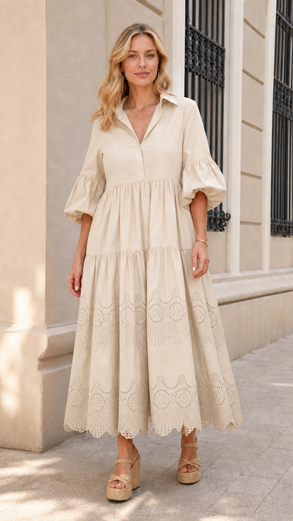 Front view of woman wearing beige collared tiered midi dress