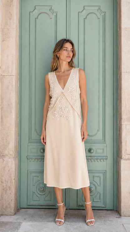 Model wearing champagne embellished sleeveless midi dress, front view