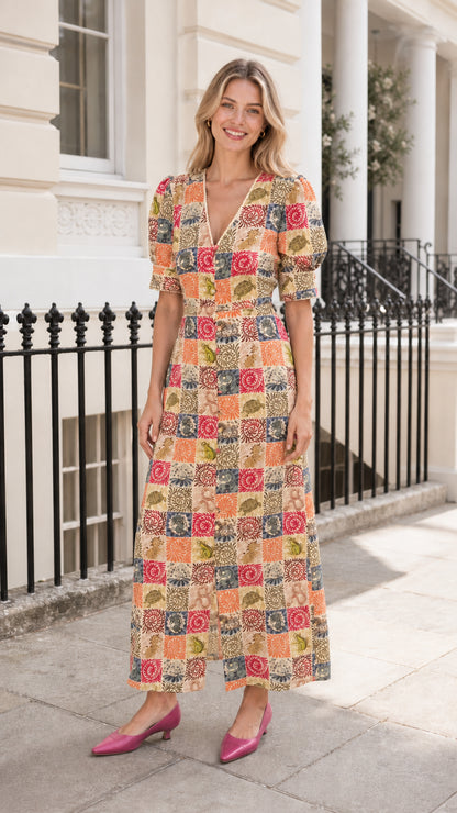 Woman wearing yellow-based patchwork midi dress outdoors