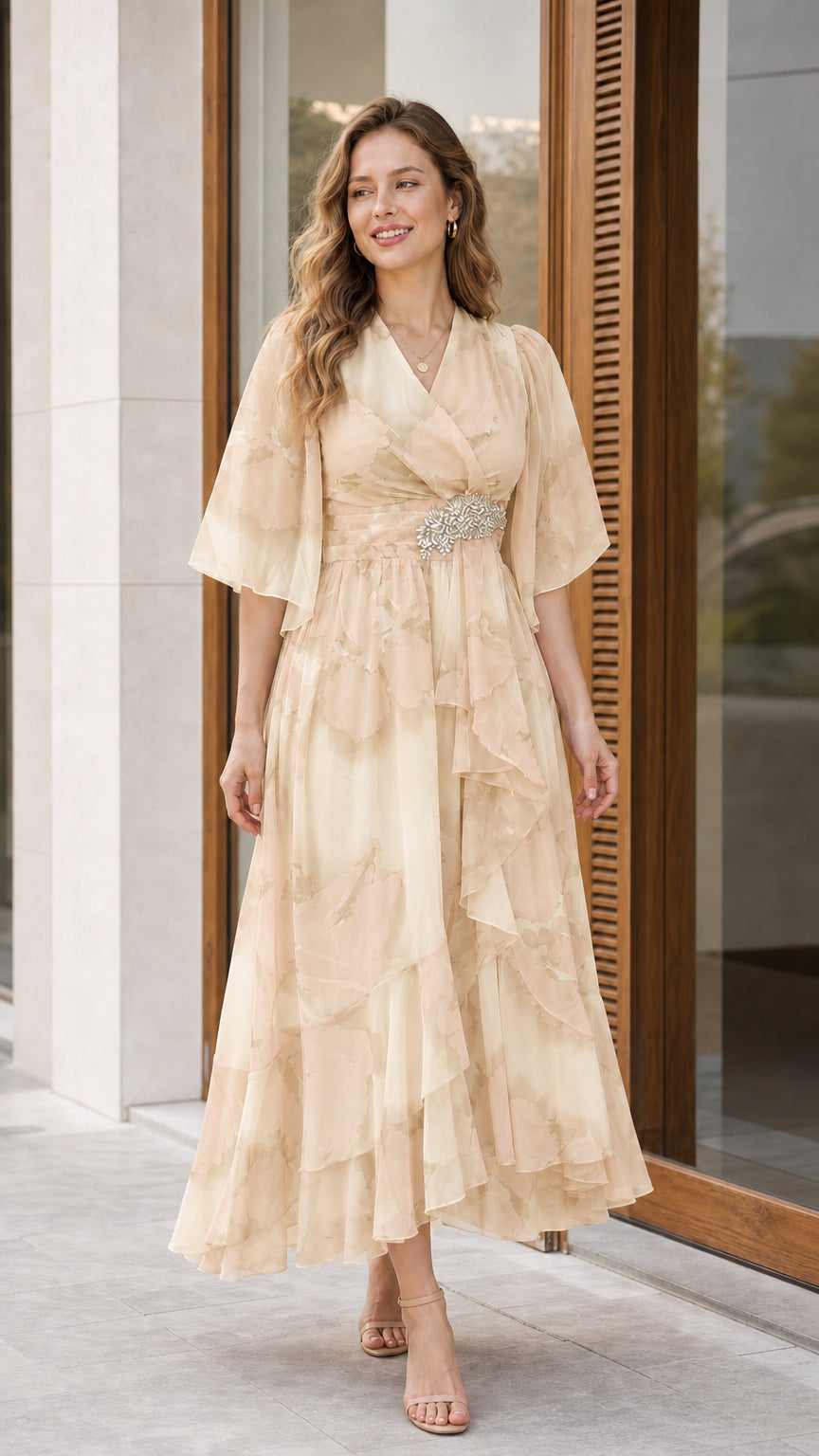 Woman wearing champagne beige floral chiffon flutter sleeve midi dress