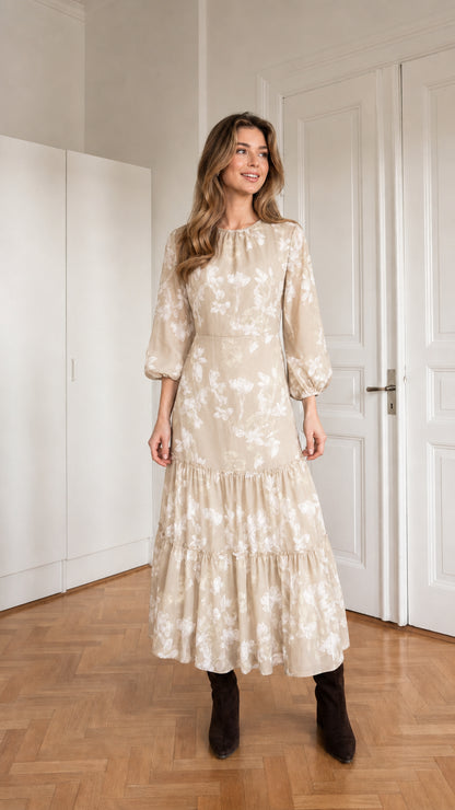 Woman wearing beige floral print long sleeve tiered midi dress
