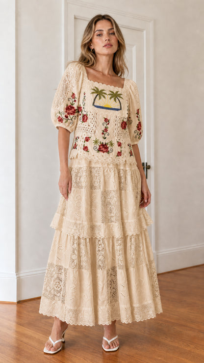 Front view of woman wearing beige embroidered maxi dress